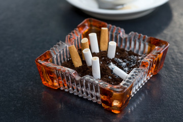 Cigarette butt on wood table