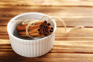 Cinnamon on a brown wooden background