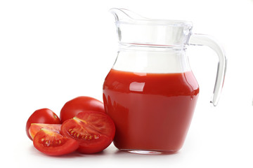 Fresh red tomatoes and tomato juice in jug isolated on white