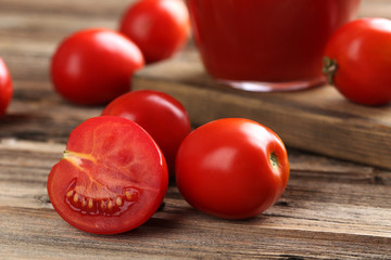 Fresh red tomatoes on brown wooden background