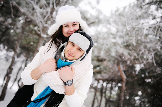 couple on the background of snowy trees