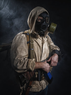 Armed man in protective mask.