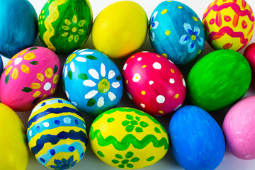 Fototapeta na wymiar Easter background of hand-painted multicolored Easter eggs. Easter symbol. Top view with copy space
