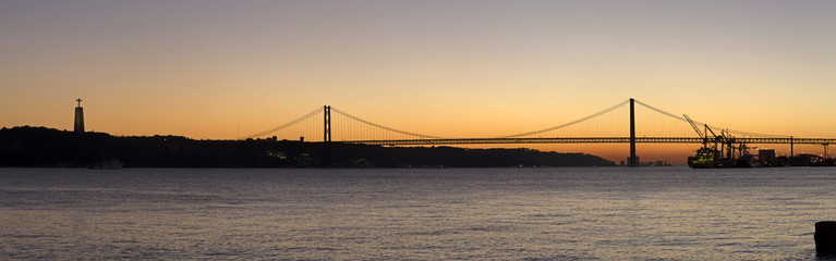 Fototapeta na wymiar Sunset view of The 25 de Abril Bridge in Lisbon, Portugal