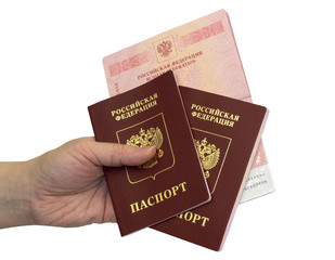 Hand with three russian passports on white background