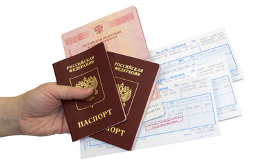 Hand with three russian passports and railway tickets on white background