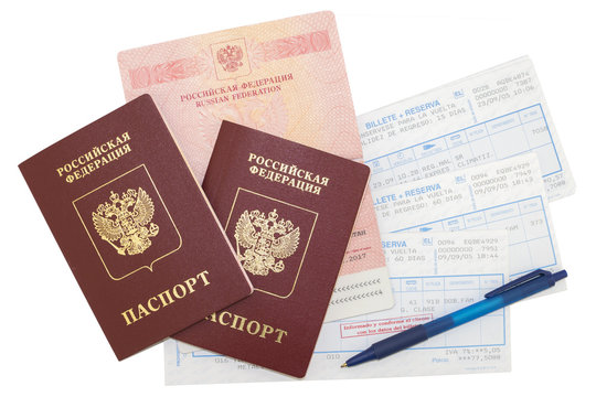 Three russian passports, railway tickets with a pen on white background