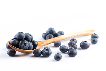 Fresh blueberries in wooden spoon