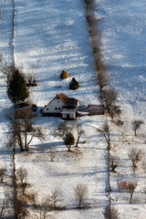 Naklejka premium Sunny day of a winter, on wild transylvania hills with Bucegi mountains in background.. 09.01.2016. Sirnea. Romania. Low key, dark background, spot lighting, and rich Old Masters
