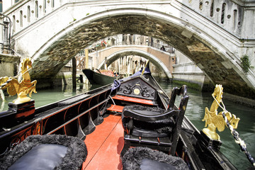 View from gondola trip during the ride through the narrow canals with many bridges in Venice Italy