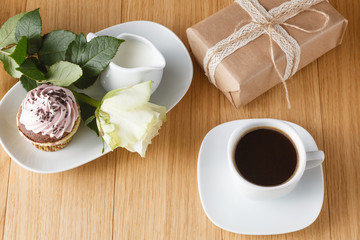 cup of black coffee and rose on desktop