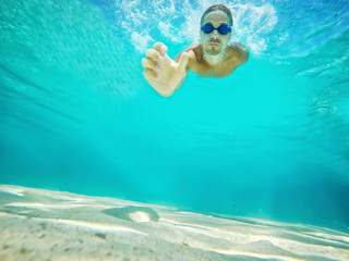 Obraz na płótnie Canvas Underwater selfie shot with selfie stick. Deep blue sea. Wide angle shot.