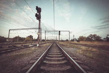 Train platform and traffic light at sunset. Railroad. Railway st