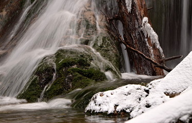 waterfall with icicles on the mountain winter river