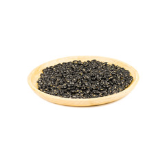 Seed black beans in wood cup isolated on white