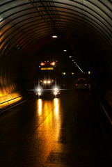 Truck in a long dark road tunnel