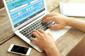 Man using laptop to book hotel online