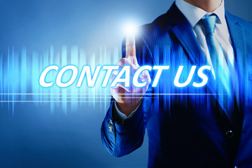 Businessman pressing contact us button on virtual screen. Internet and networking concept.