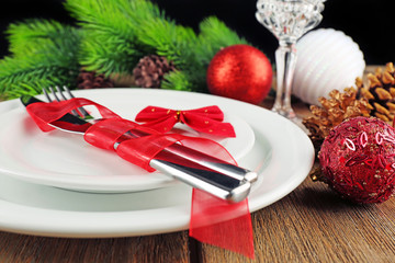 Table setting with Christmas decoration on wooden background