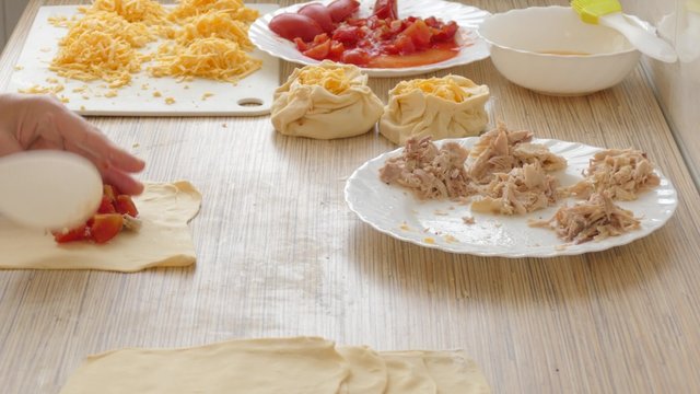 filling pies food ingredients-chicken meat, cheese, tomatoes and forming of patties stuffed

