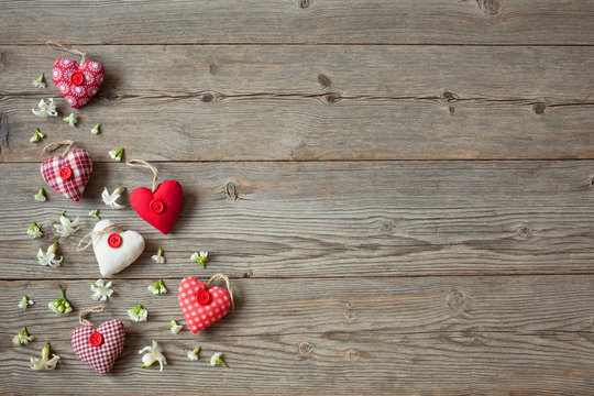 Wooden background with red hearts and flowers