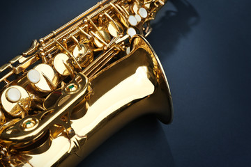 Beautiful golden saxophone on black background, close up