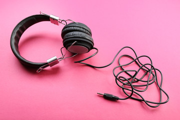 Black headphones on pink background