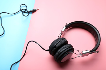 Black headphones on pink-blue background