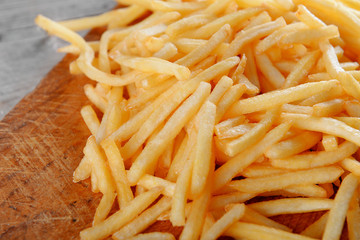French fried potatoes on cutting board