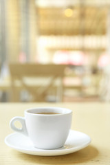 Cup of tasty coffee on cafe background