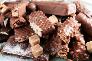 Chocolate sweets with powder on wooden background