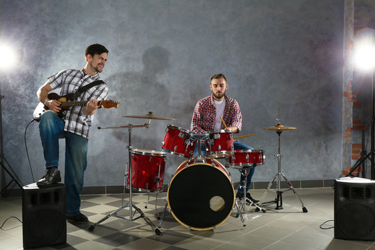 Musicians playing the drums in a studio