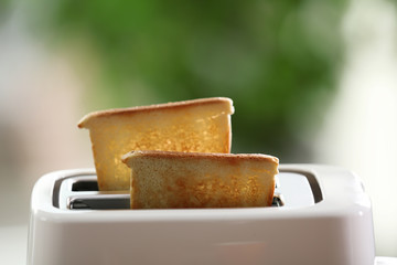 A couple of crusty toasts in the toaster, close-up