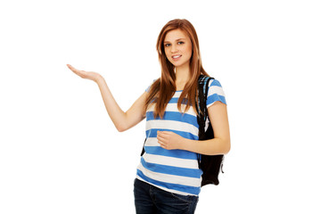 Teenage woman showing something on open palm