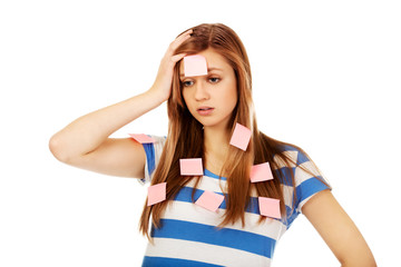 Teenage woman covered with post it notes