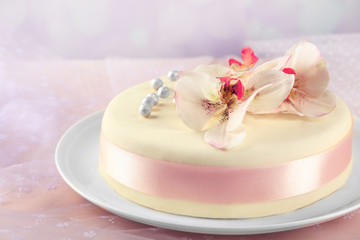 Fototapeta na wymiar Cake with sugar paste flowers, on light background