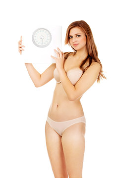 Slim woman holding a scale