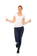 Young happy woman gesturing thumbs up