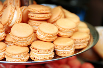 Beige macaroons on plate closeup