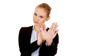 Young business woman trying to protect herself