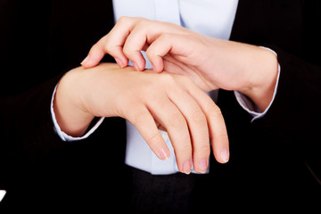 Young elegant woman scratching her hand