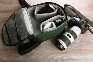 Photographer's equipment on a light wooden background