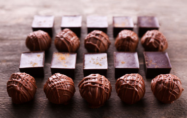 Delicious chocolate candies on wooden background