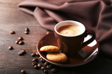 Cup of coffee on wooden table background