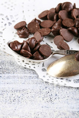 Chocolate morsels on gray background