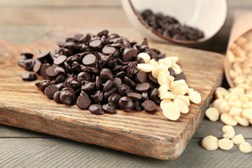 Chocolate morsels on wooden background