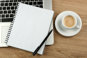 Empty  notebook on laptop keyboard, on light background