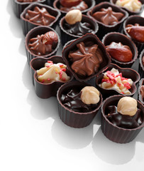 Delicious chocolate candies on white background