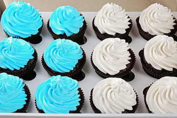 Tasty cupcakes in paper box, close up