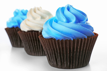 Fresh delicious cupcakes in a row isolated on white background